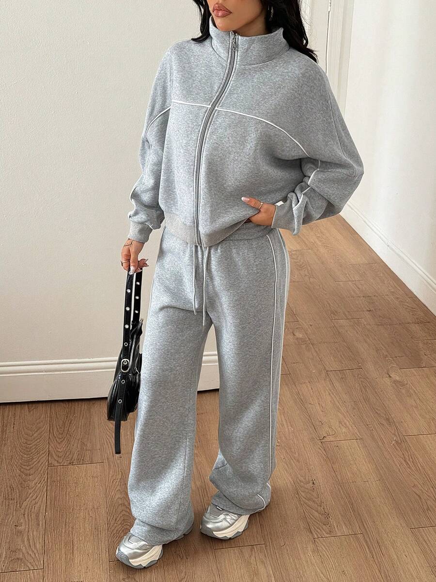 Women's two-piece casual set featuring a long sleeve zip-front hoodie and matching drawstring pants.