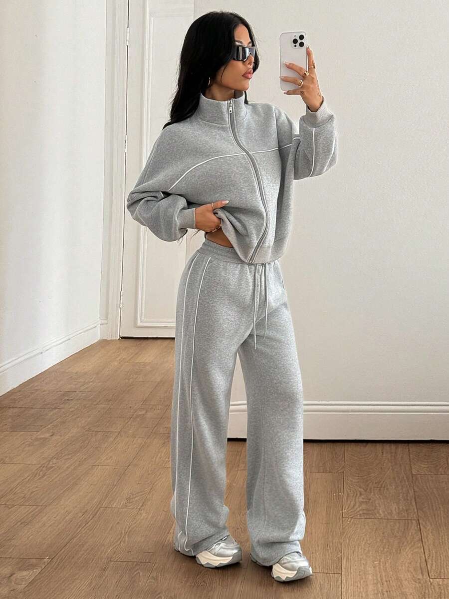 Women's two-piece casual set featuring a long sleeve zip-front hoodie and matching drawstring pants.