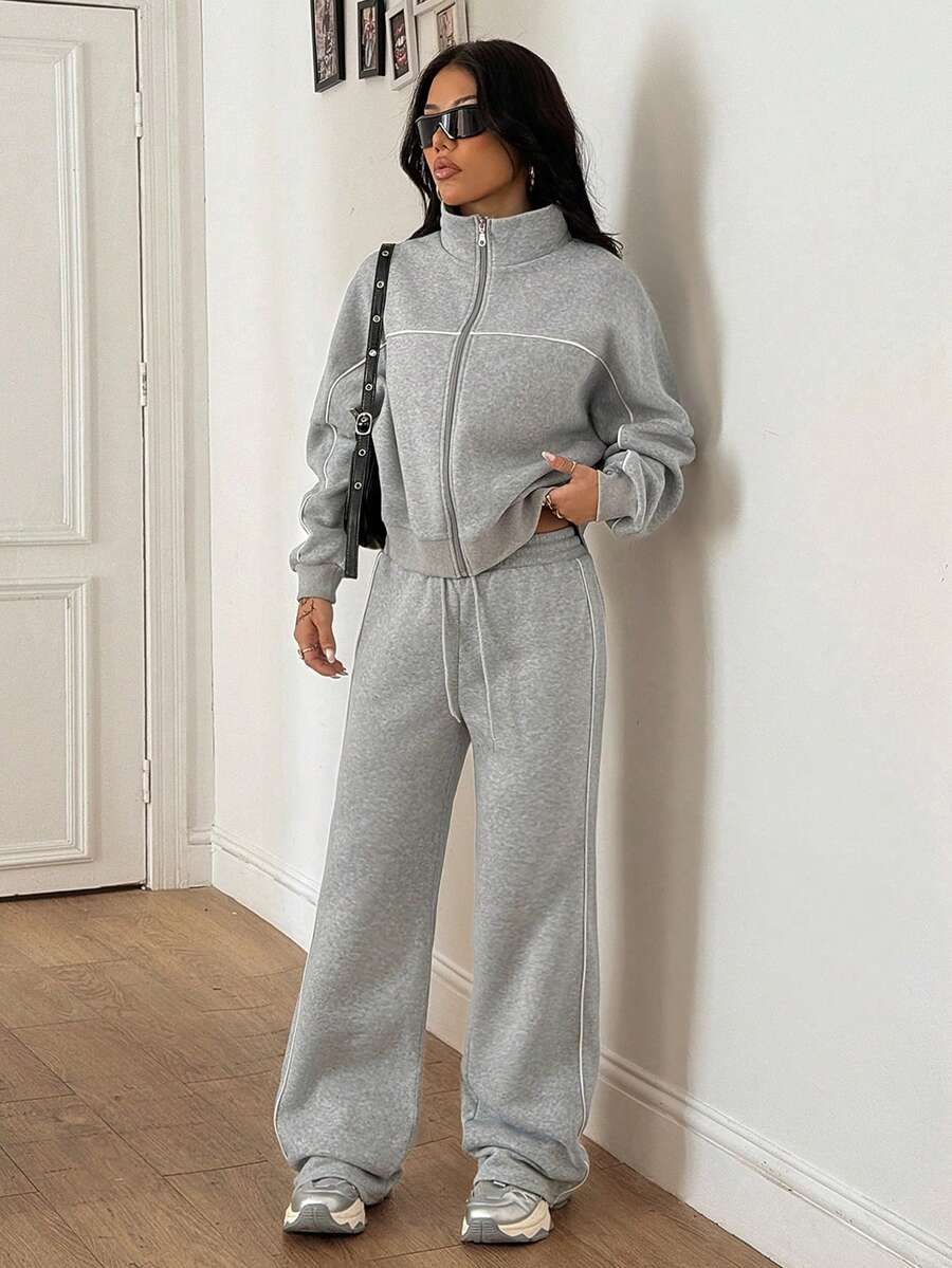 Women's two-piece casual set featuring a long sleeve zip-front hoodie and matching drawstring pants.