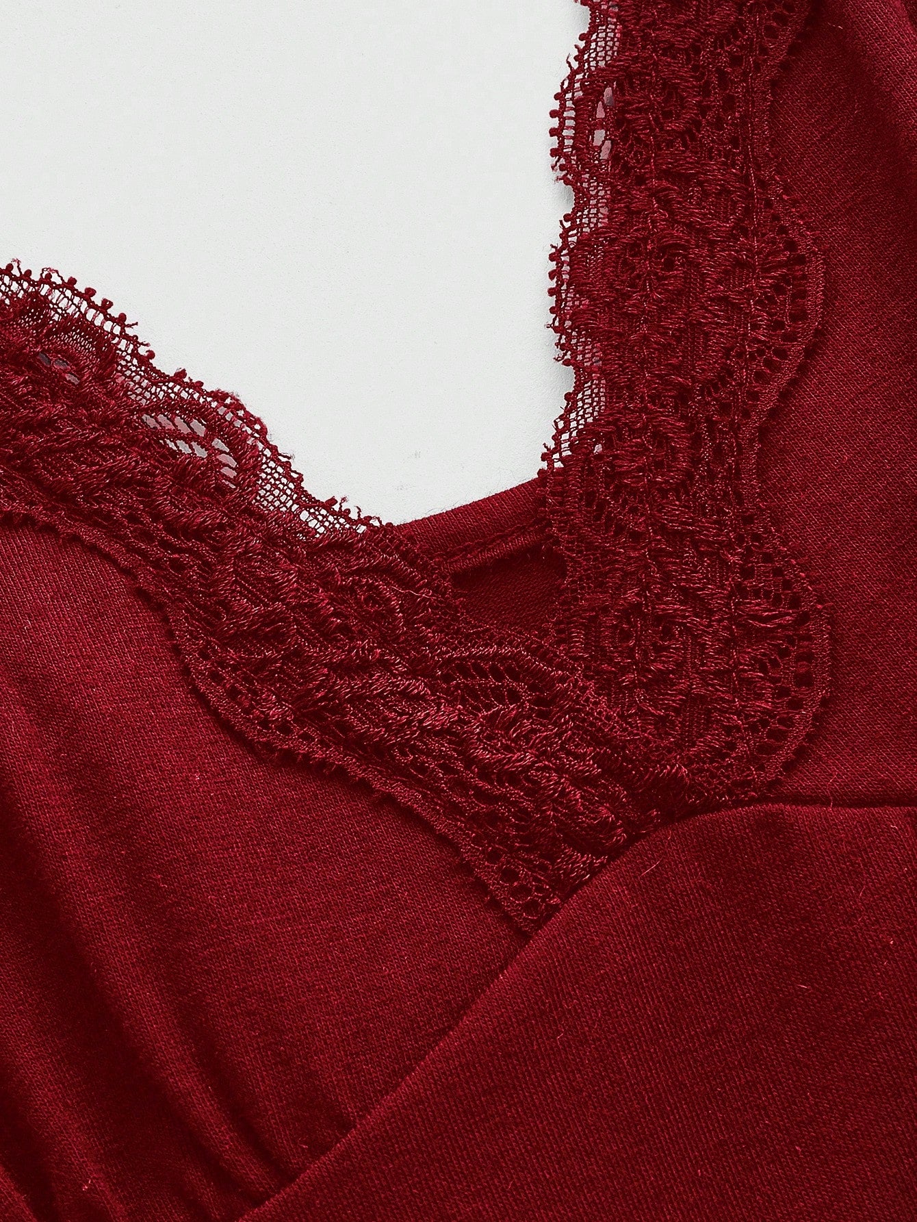 Women's spaghetti strap camisole with contrast lace patchwork, slim fit silhouette, plain design, and flared hem.