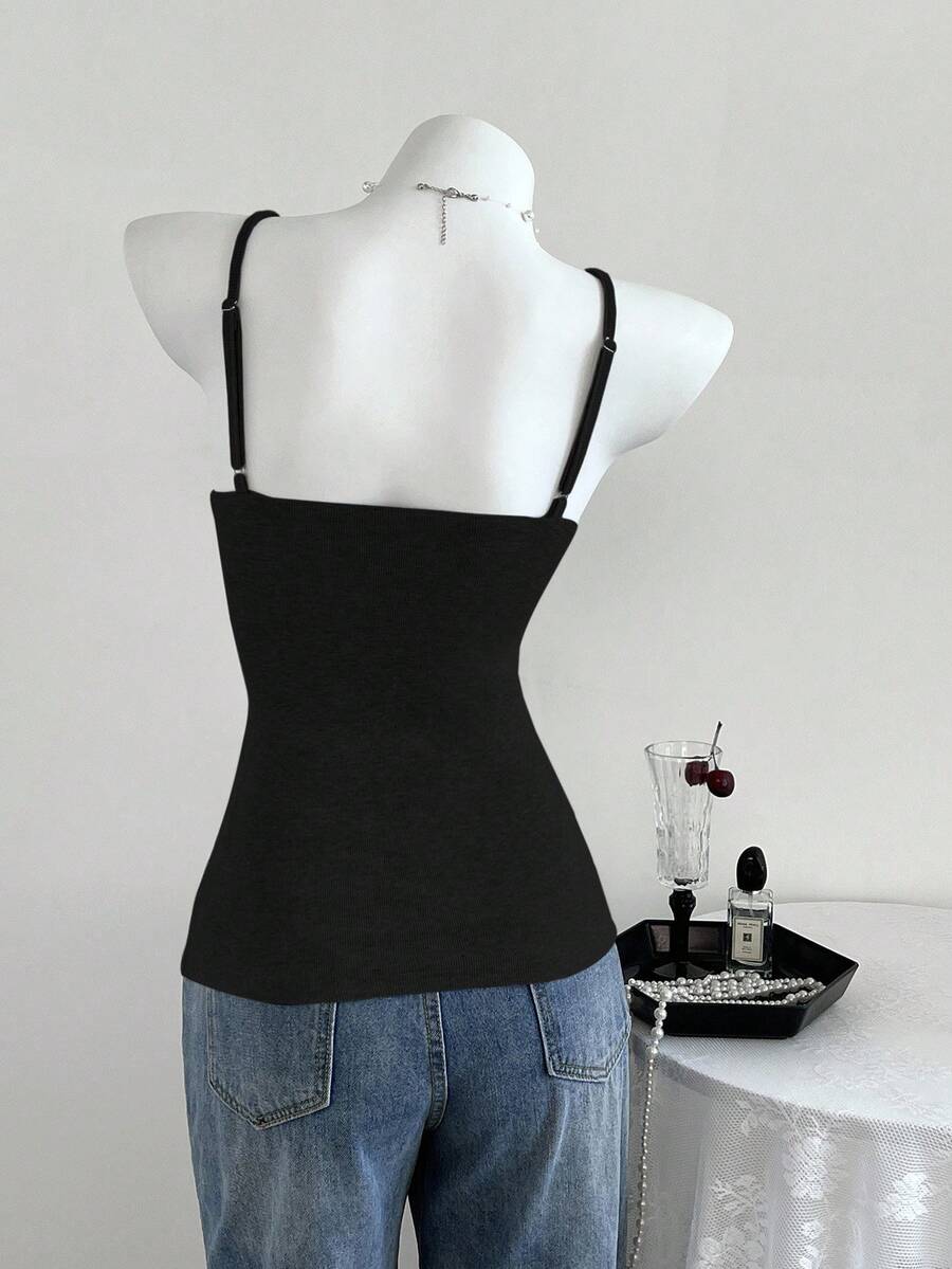 Women's slim fit backless cami tank top with contrast lace patchwork details, spaghetti straps, and high-stretch knitted ribbed fabric.