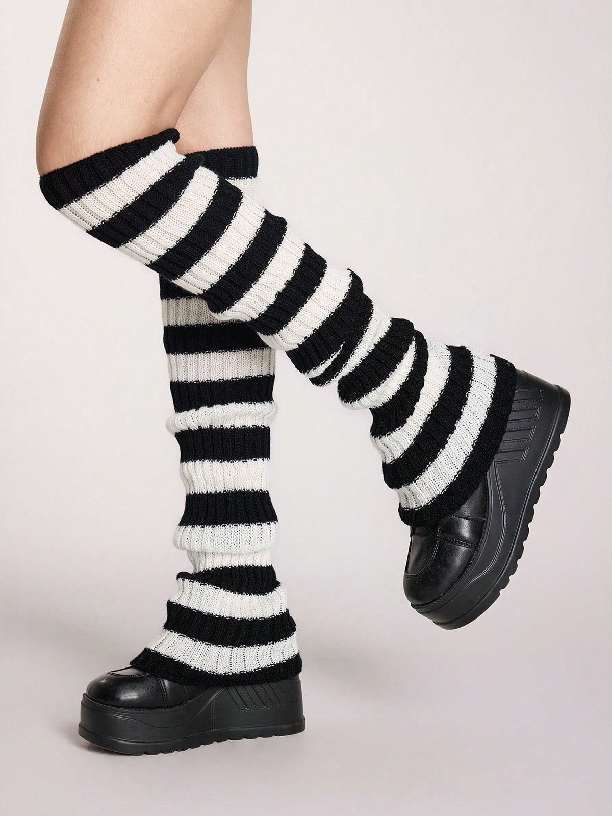 Pair of women's extra long knitted leg warmers featuring a gothic grunge design with subtle ruffle detailing.