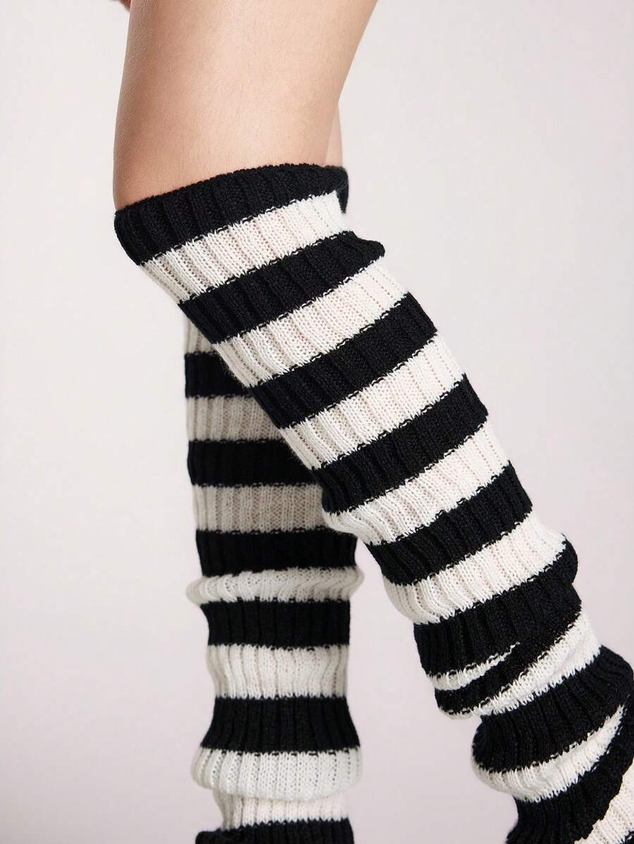 Pair of women's extra long knitted leg warmers featuring a gothic grunge design with subtle ruffle detailing.