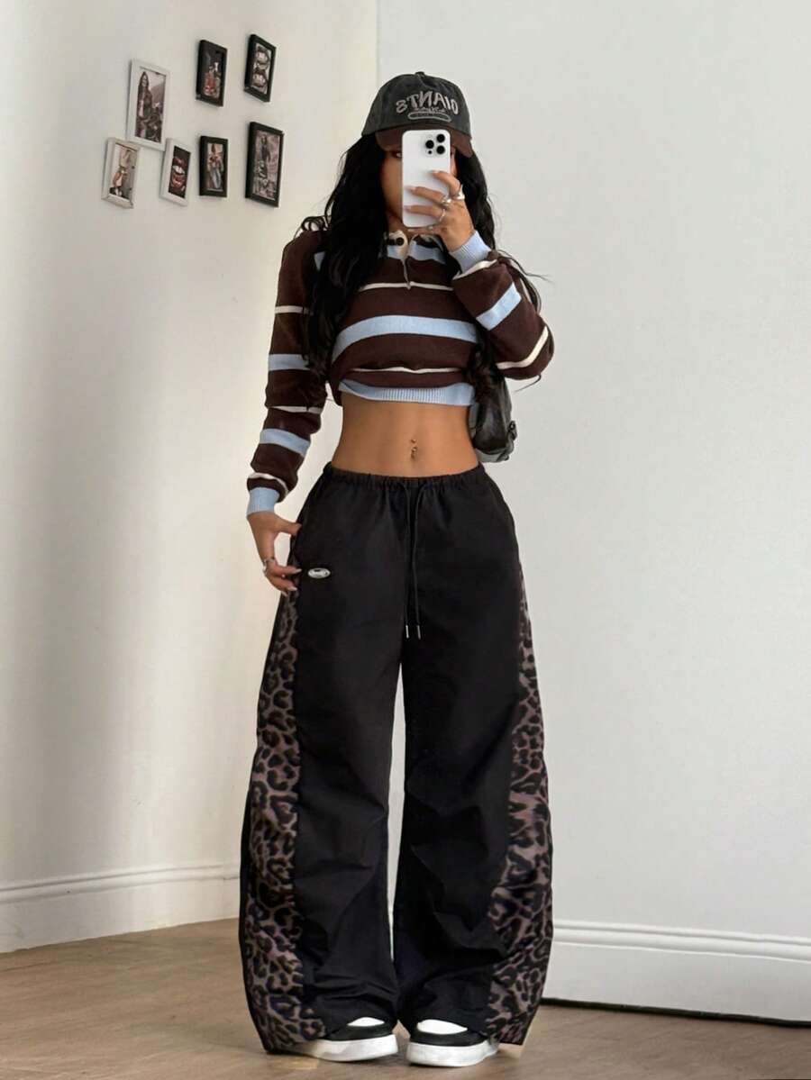 Women's black baggy jogger pants with an adjustable drawstring waist and colorblock polka dot geometric pattern.