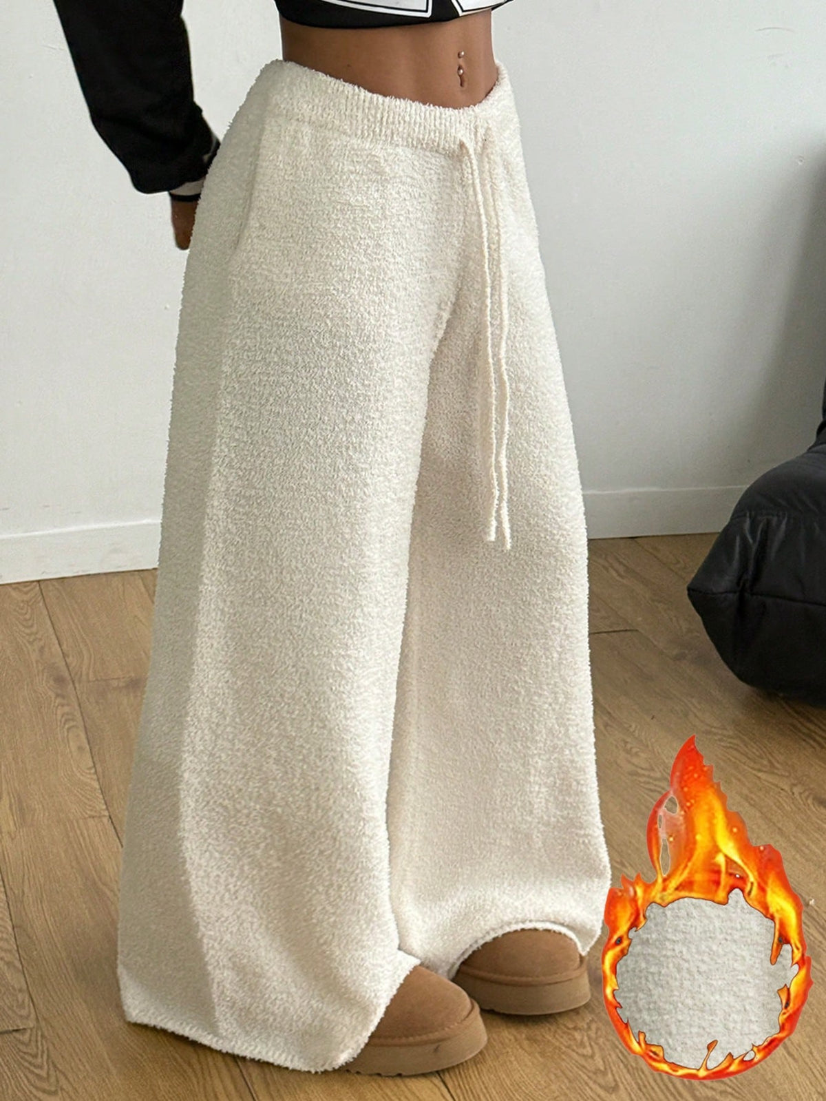 White fuzzy knit sweater pants for women with a drawstring waist and relaxed straight leg cut.
