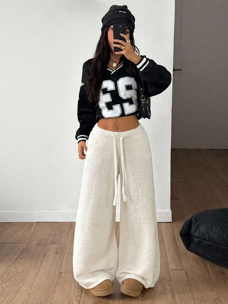White fuzzy knit sweater pants for women with a drawstring waist and relaxed straight leg cut.