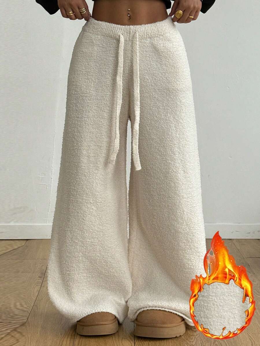 White fuzzy knit sweater pants for women with a drawstring waist and relaxed straight leg cut.