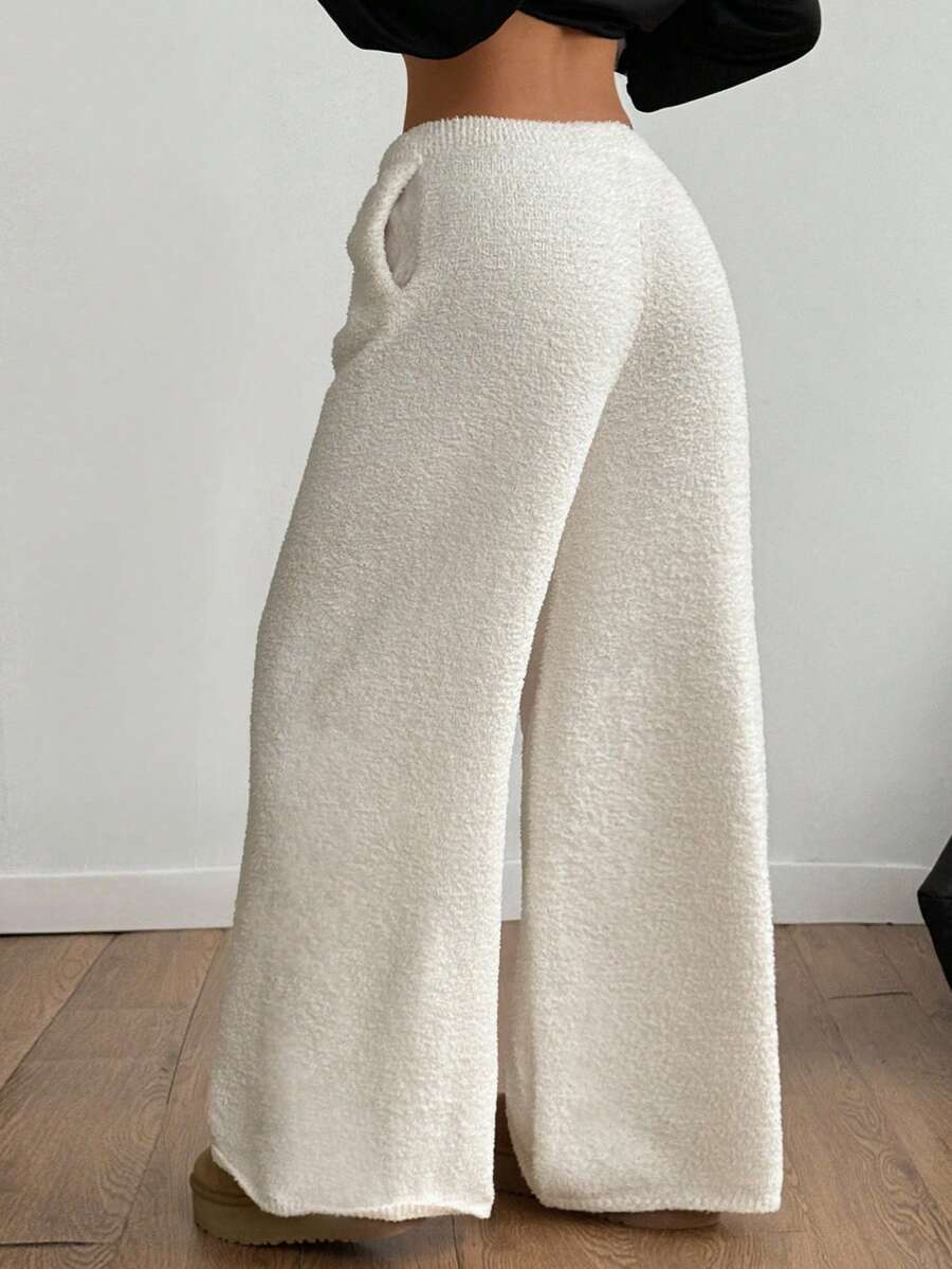 White fuzzy knit sweater pants for women with a drawstring waist and relaxed straight leg cut.