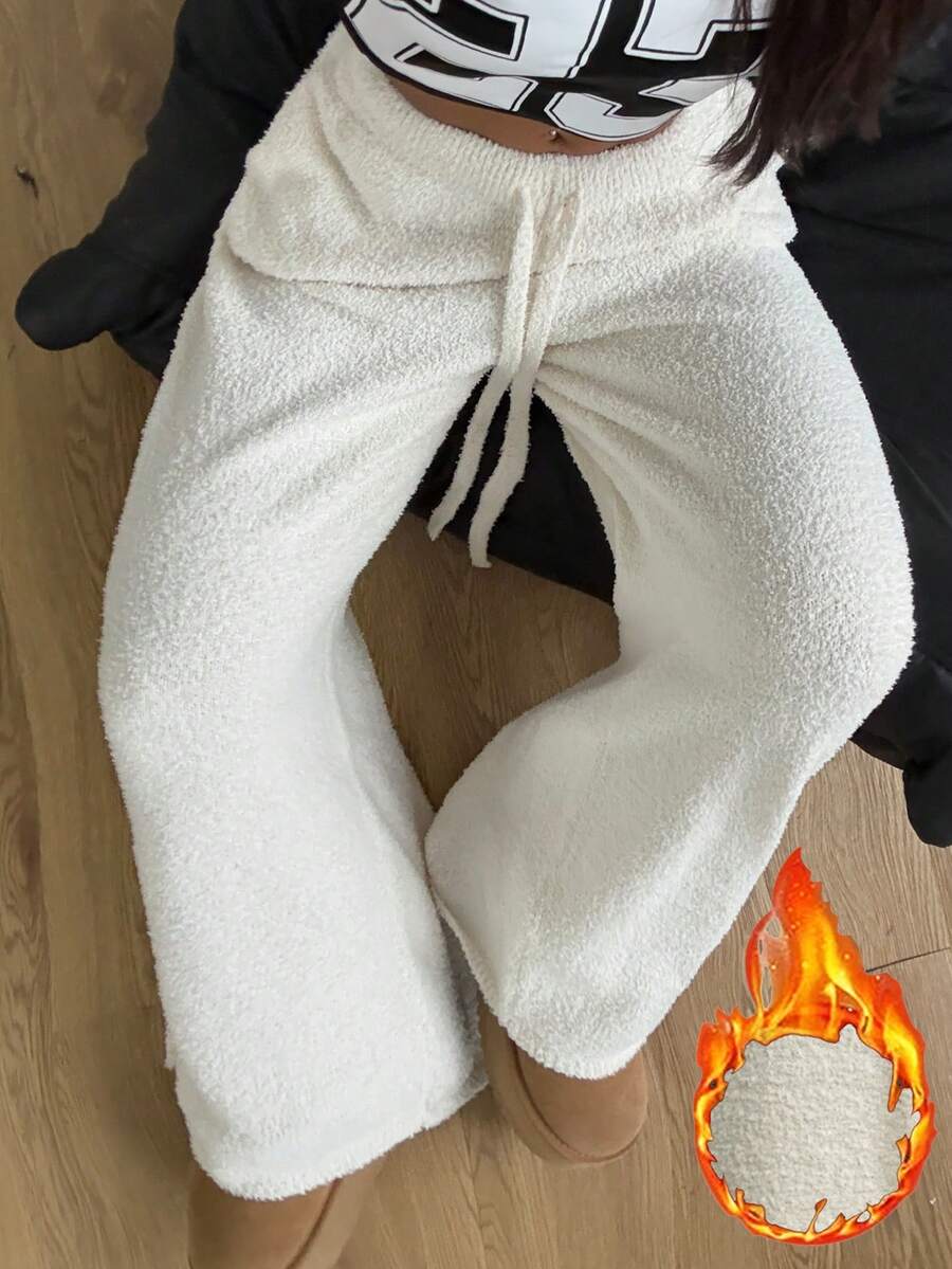 White fuzzy knit sweater pants for women with a drawstring waist and relaxed straight leg cut.