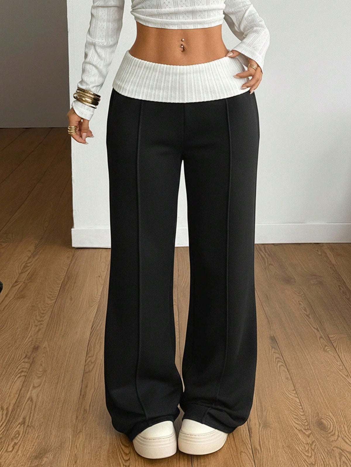 Women's wide leg flare sweatpants featuring a black and white colorblock contrast fold waistband and side stripe details.