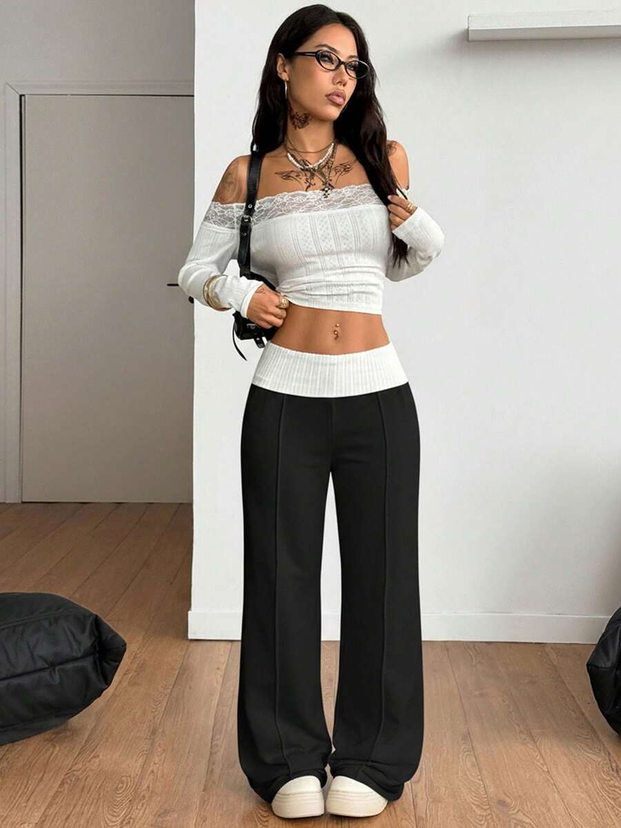 Women's wide leg flare sweatpants featuring a black and white colorblock contrast fold waistband and side stripe details.