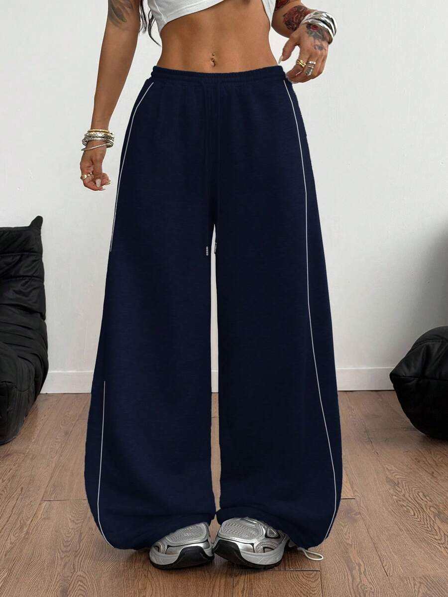 Women's wide leg trousers with a tree branch graphic pattern, loose fit, and mid-rise waist in woven fabric.