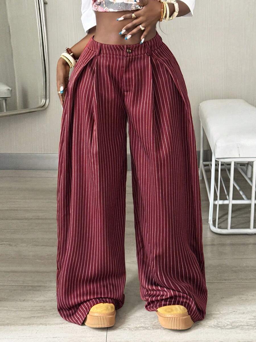 Women's brown striped wide leg pants with a low waist, curved hem, and loose casual fit in woven fabric.