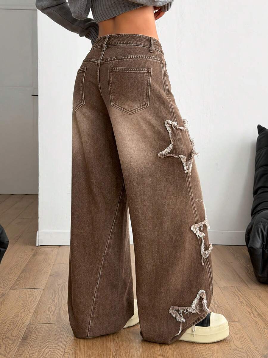 Front view of women's loose wide leg denim jeans featuring a mid waist, classic front pockets, and a zipper fly closure.