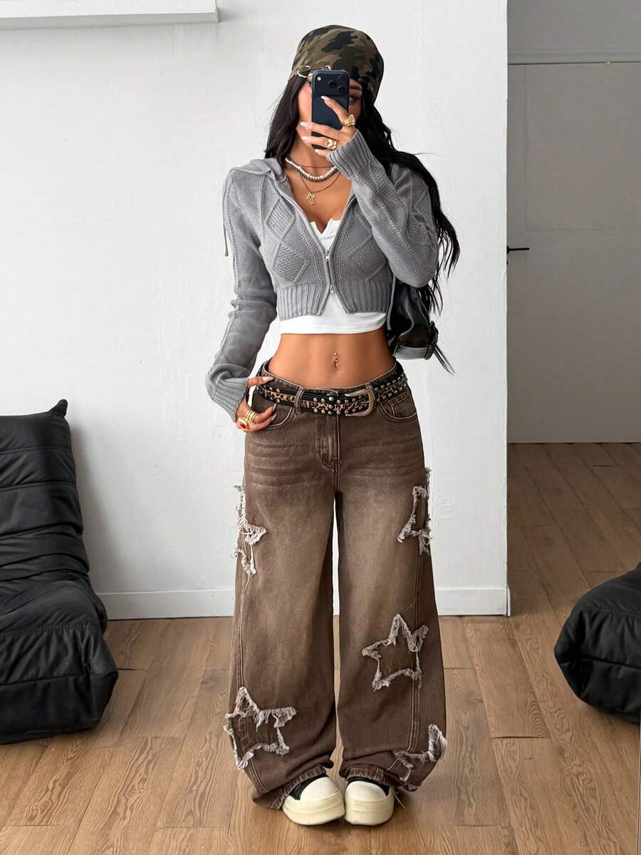 Front view of women's loose wide leg denim jeans featuring a mid waist, classic front pockets, and a zipper fly closure.