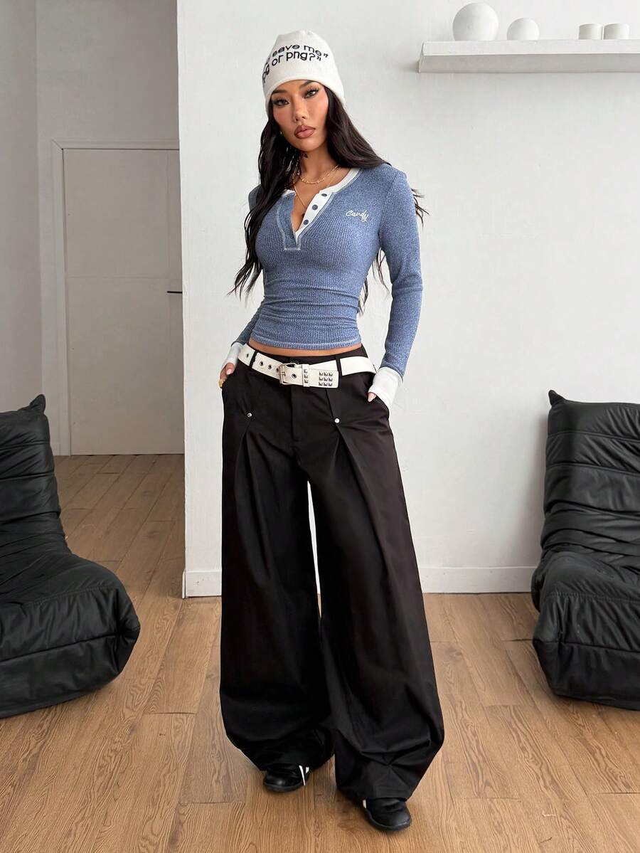 Women's slim fit ribbed knit henley shirt with long sleeves and front button placket detail.