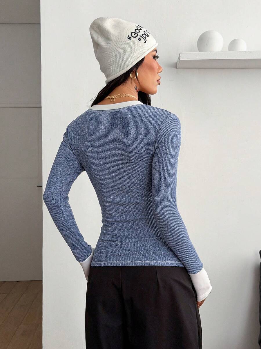 Women's slim fit ribbed knit henley shirt with long sleeves and front button placket detail.