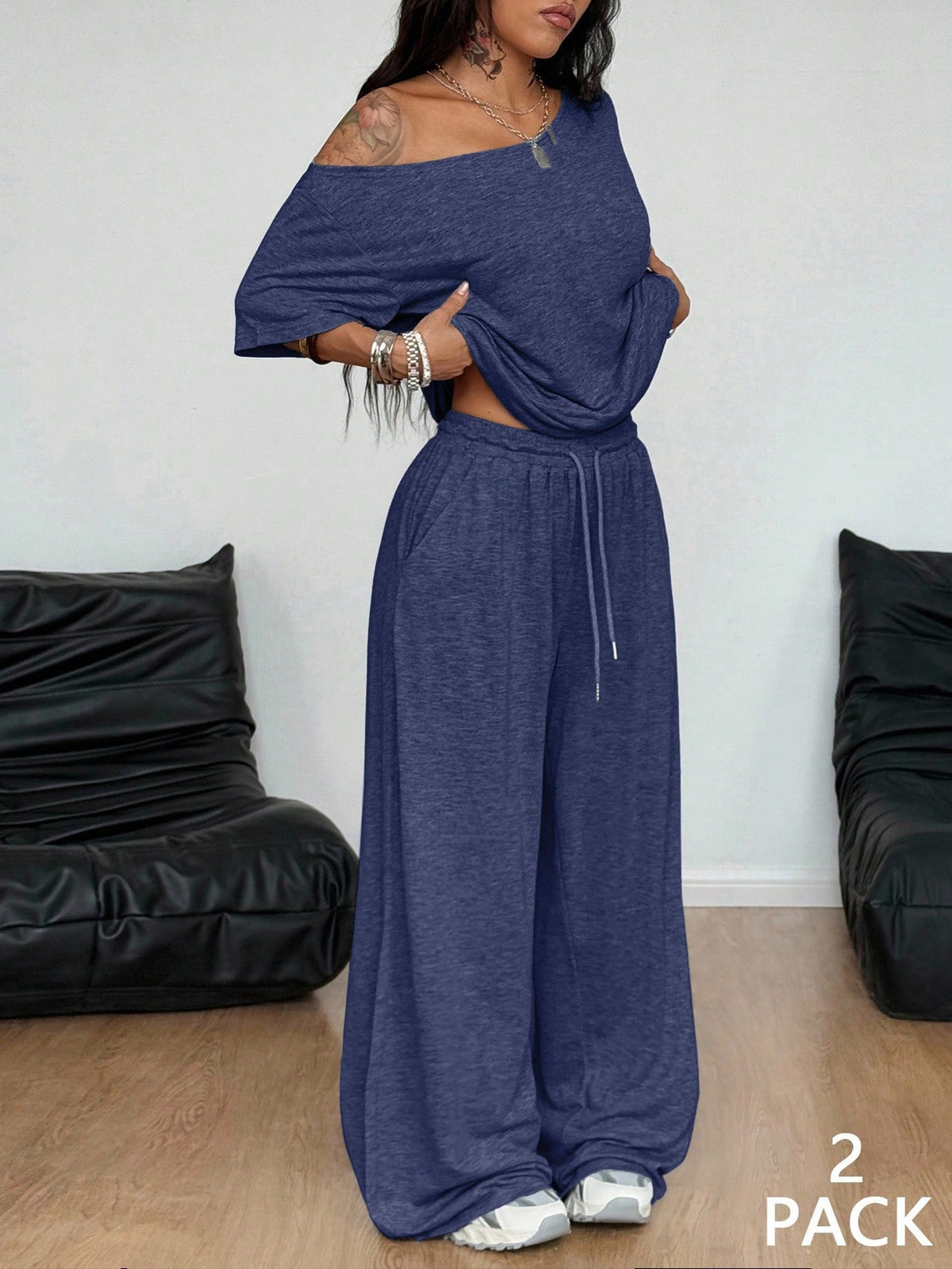 Women's two-piece outfit featuring an oversized asymmetrical neck t-shirt and matching wide-leg drawstring sweatpants.