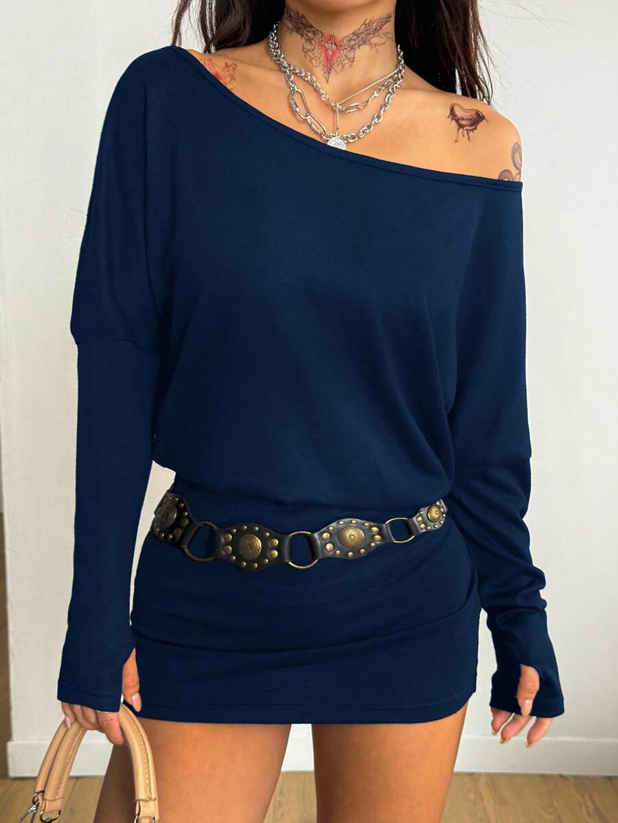 Women's long sleeve bodycon mini dress in black knitted fabric with an asymmetrical neckline and ruched accents.
