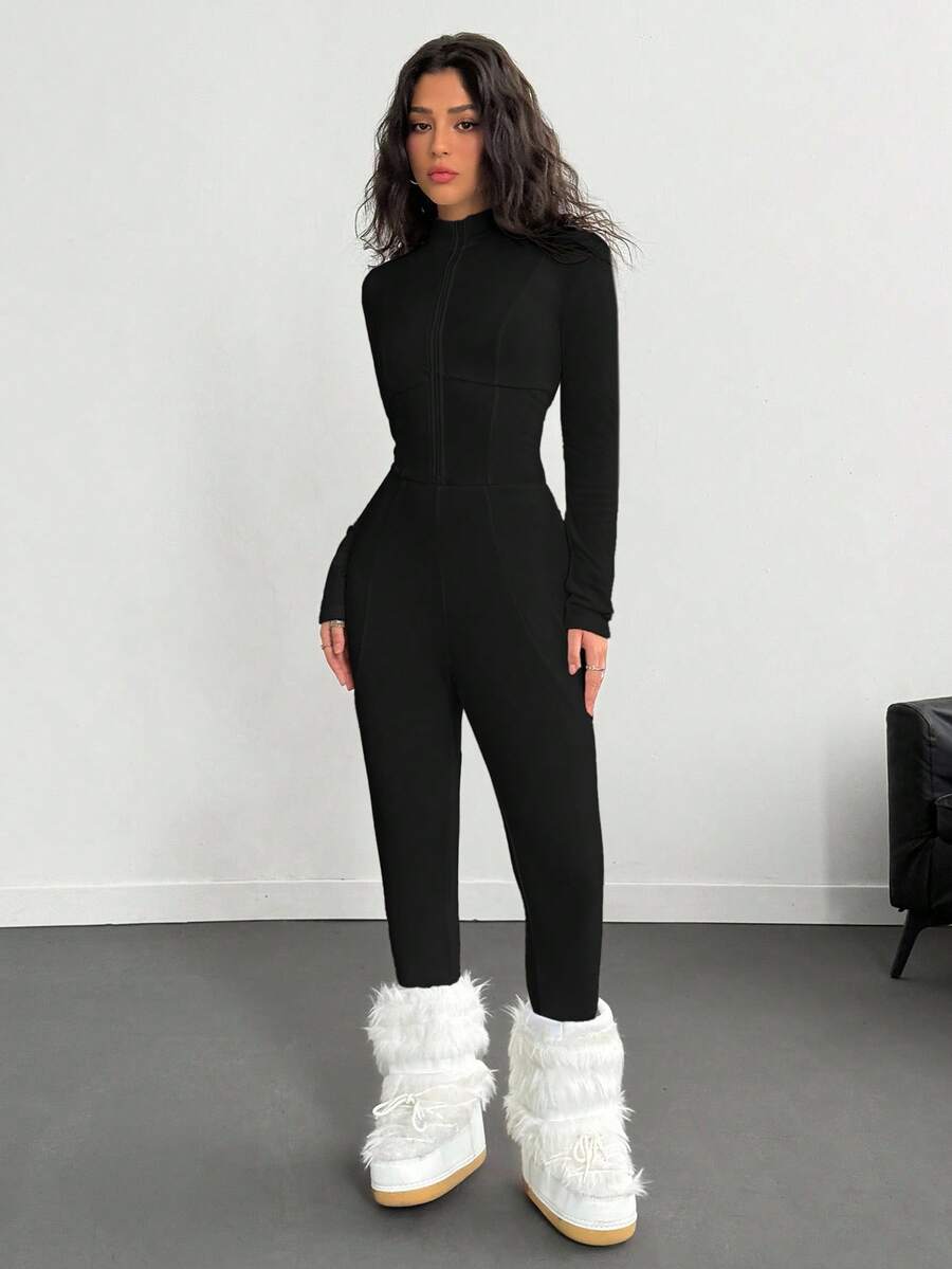 Fitted long sleeve unitard jumpsuit for women featuring a stand collar and front zipper closure in a solid color athletic style.