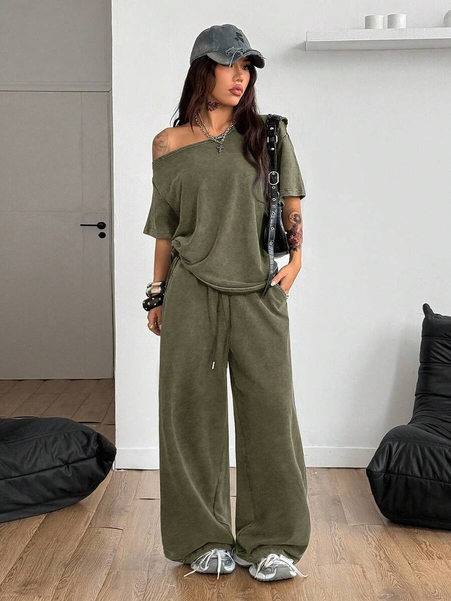 Women's two-piece outfit featuring an oversized asymmetrical neck t-shirt and matching wide-leg drawstring sweatpants.