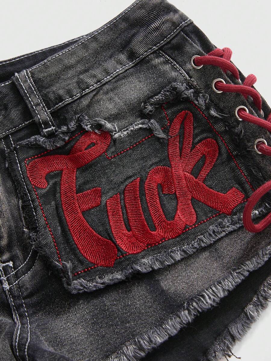 Women's Y2K low waist camo mini skort shorts featuring lace-up knot details, grommet eyelets, graphic lettering pattern, and a zipper fly.
