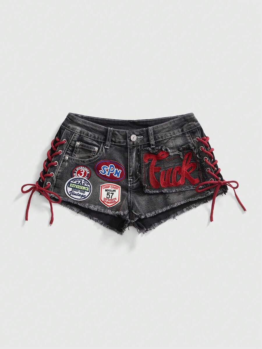 Women's Y2K low waist camo mini skort shorts featuring lace-up knot details, grommet eyelets, graphic lettering pattern, and a zipper fly.