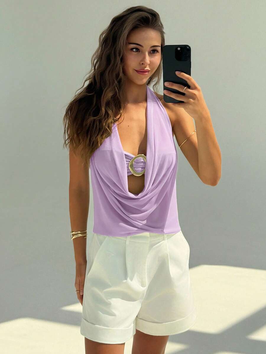 Semi-sheer plunging halter backless top with draped knot details and metallic decor, shown as a short slim-fit mesh going-out top.