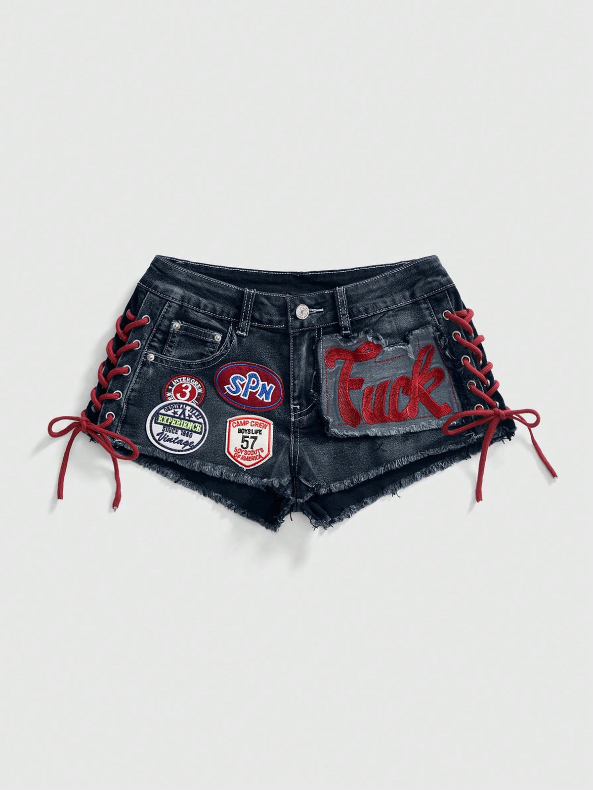 Women's Y2K low waist camo mini skort shorts featuring lace-up knot details, grommet eyelets, graphic lettering pattern, and a zipper fly.