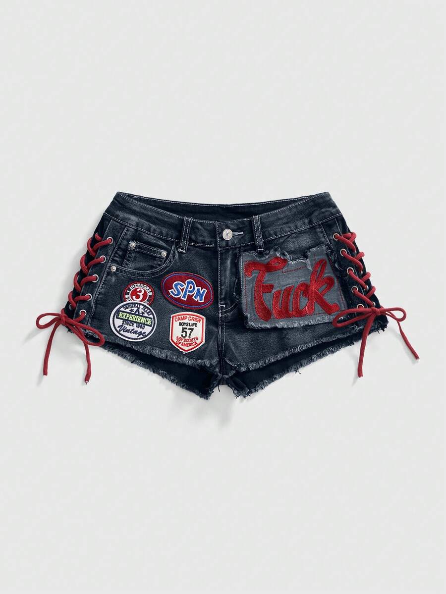 Women's Y2K low waist camo mini skort shorts featuring lace-up knot details, grommet eyelets, graphic lettering pattern, and a zipper fly.