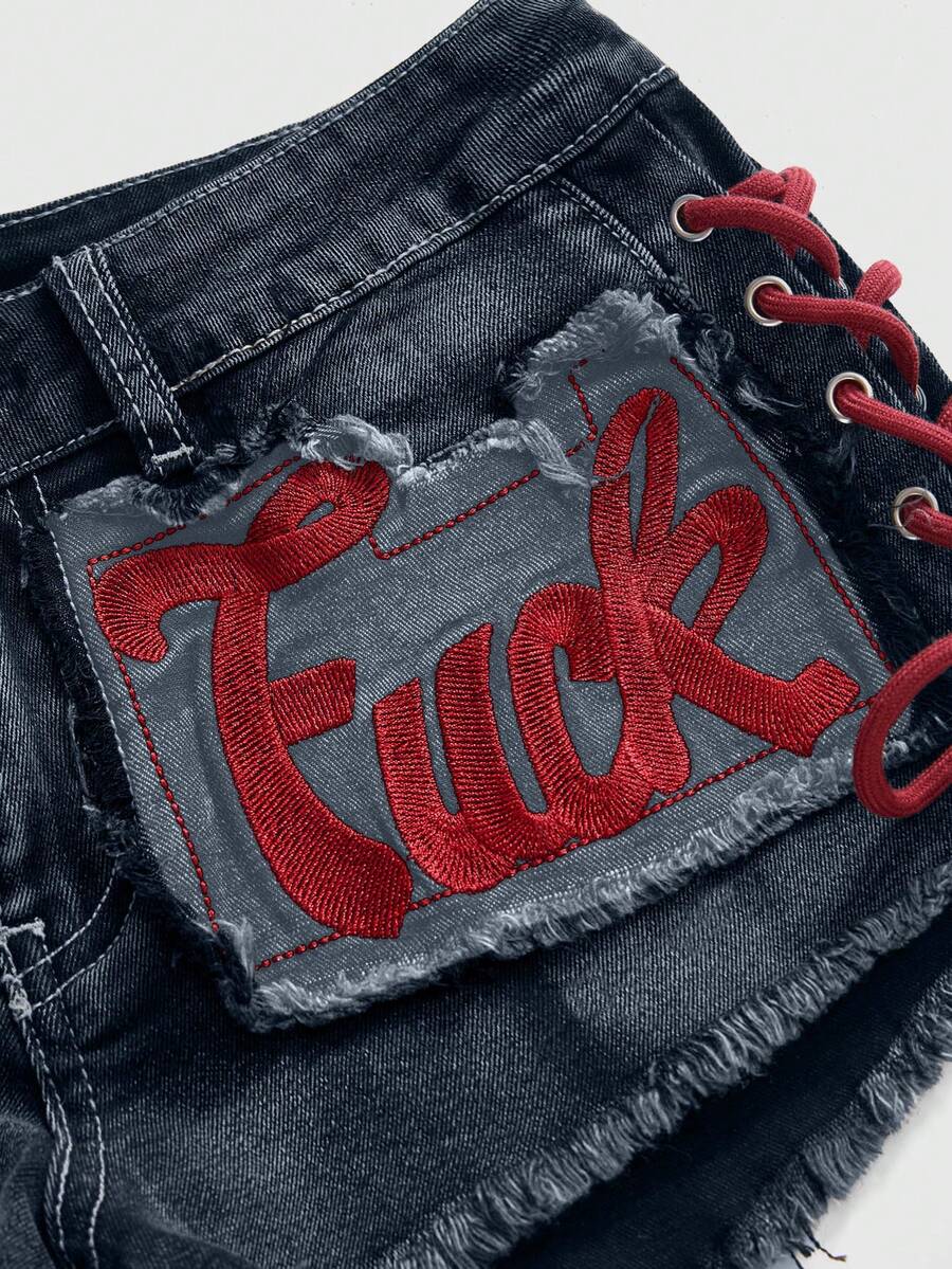 Women's Y2K low waist camo mini skort shorts featuring lace-up knot details, grommet eyelets, graphic lettering pattern, and a zipper fly.