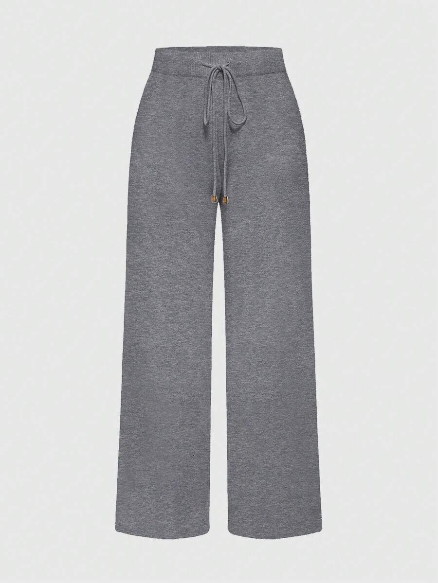 Women's two-piece rib-knit sweater set featuring a long-sleeve cold-shoulder crop top with strap details and matching wide-leg pants.