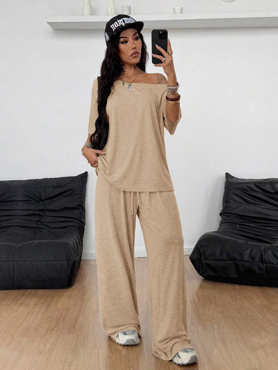 Women's two-piece outfit featuring an oversized asymmetrical neck t-shirt and matching wide-leg drawstring sweatpants.