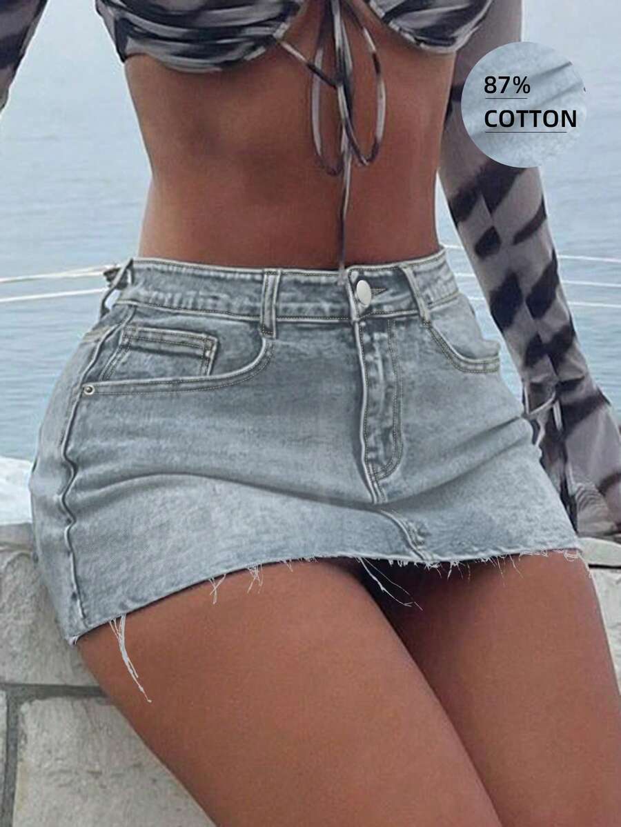 Y2K distressed mini skort with button and pocket details, natural mid waist, regular fit, and casual streetwear styling.