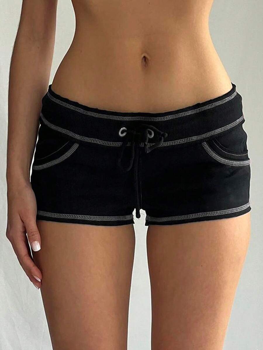 Women's low waist track shorts with drawstring waist, zipper detail, and mini length in a casual skinny fit