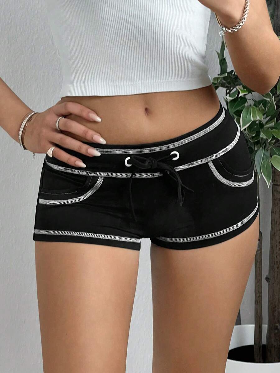Women's low waist track shorts with drawstring waist, zipper detail, and mini length in a casual skinny fit