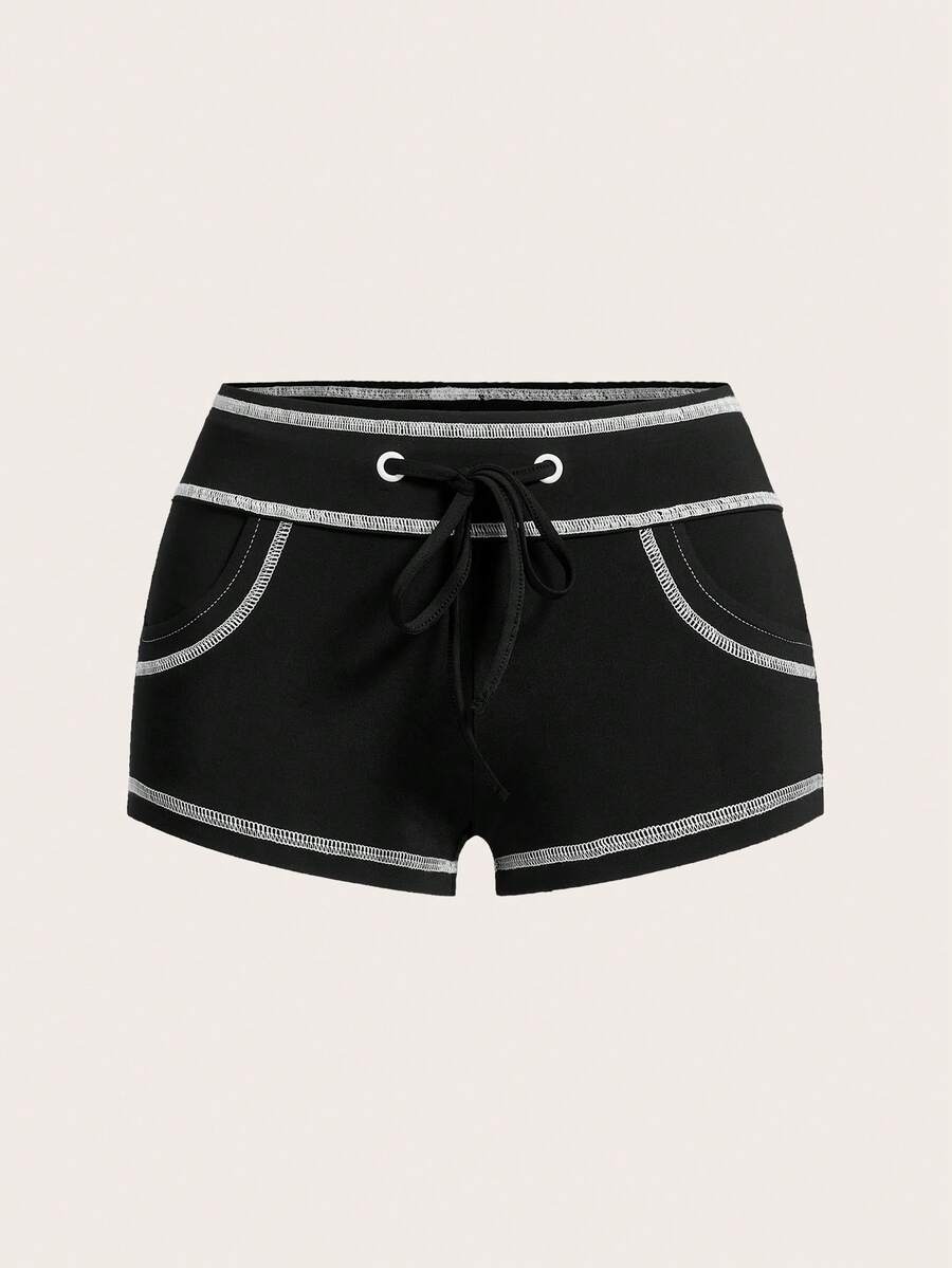 Women's low waist track shorts with drawstring waist, zipper detail, and mini length in a casual skinny fit