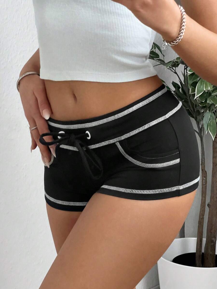 Women's low waist track shorts with drawstring waist, zipper detail, and mini length in a casual skinny fit