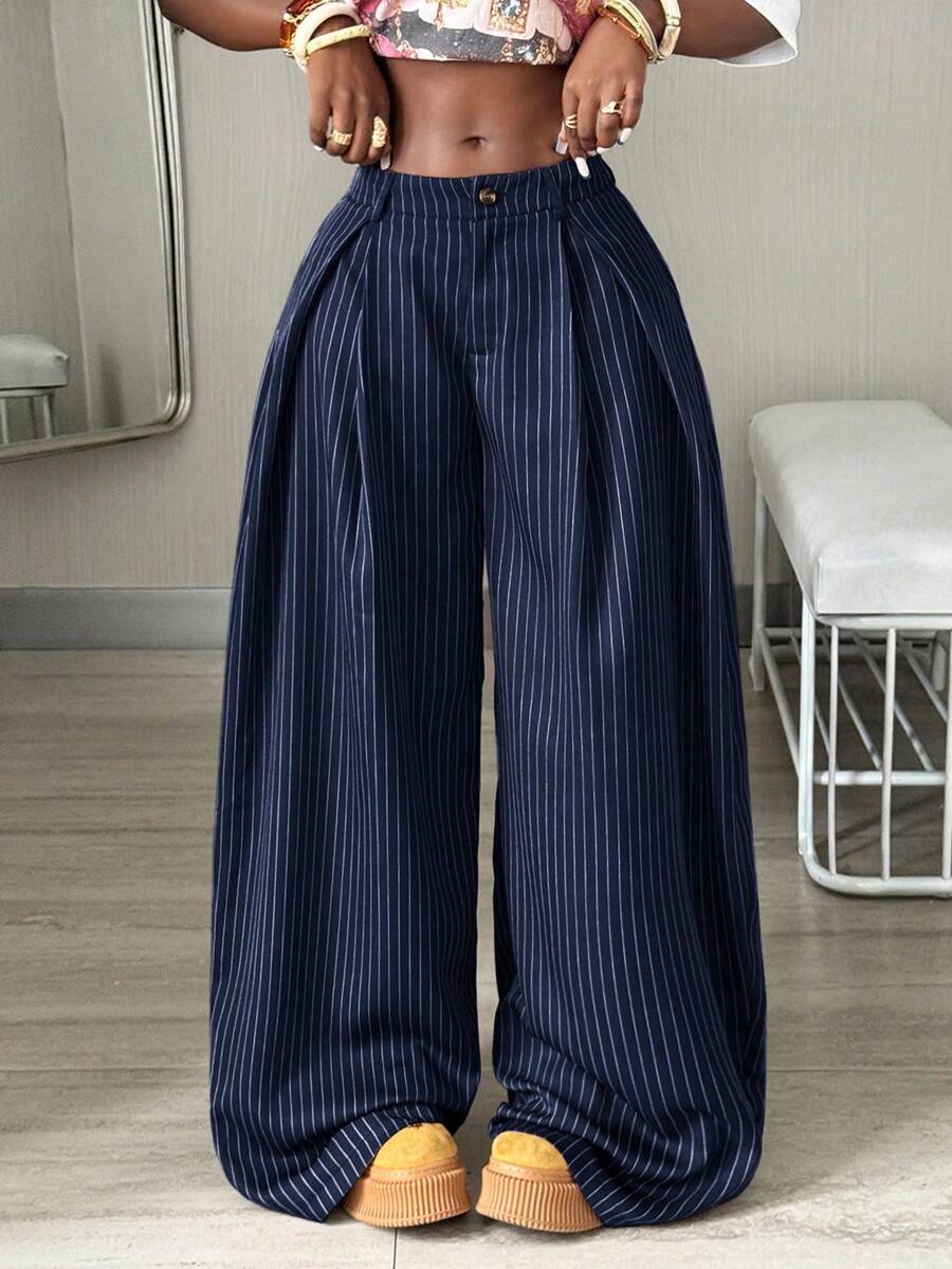 Women's brown striped wide leg pants with a low waist, curved hem, and loose casual fit in woven fabric.