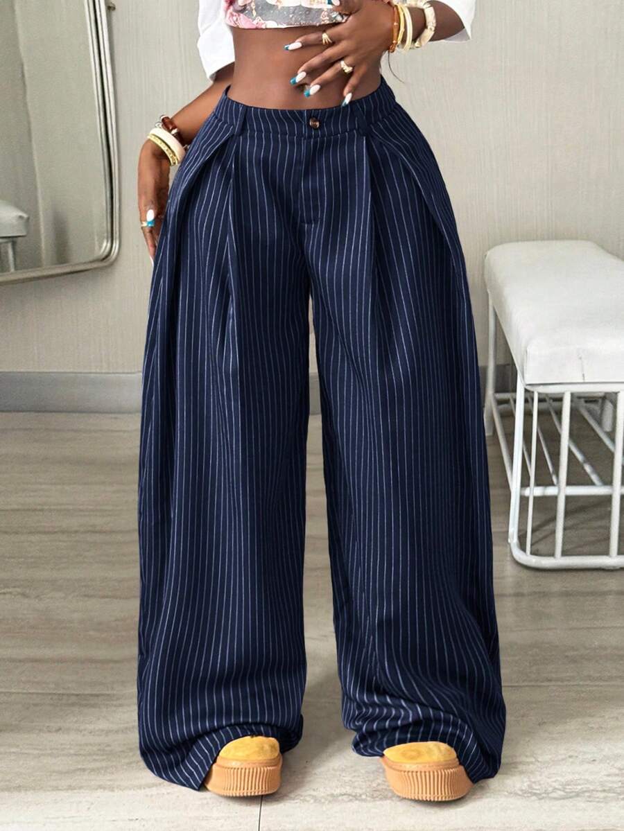 Women's brown striped wide leg pants with a low waist, curved hem, and loose casual fit in woven fabric.