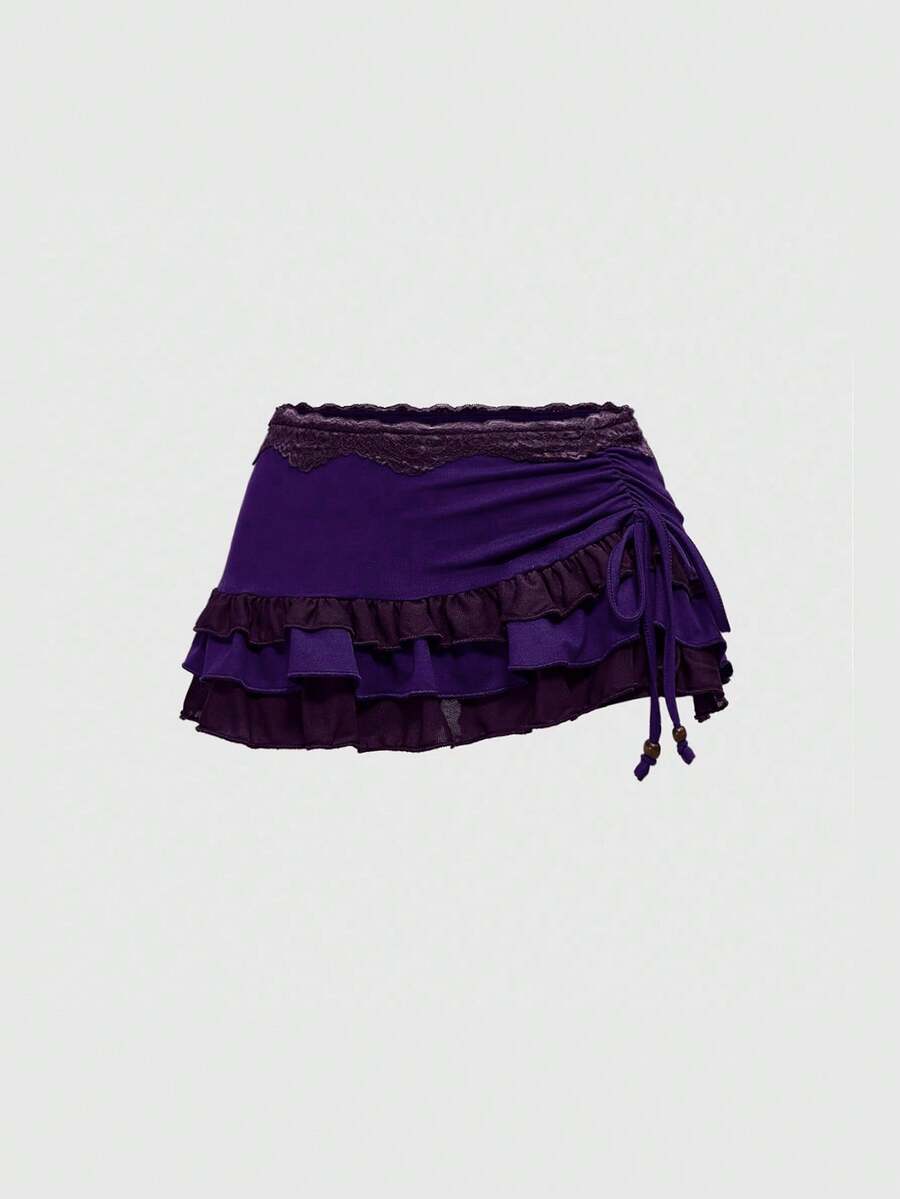 Women's black low-waist mini skirt with drawstring tie, ruched details, lace trim, layered ruffle hem, and asymmetric styling