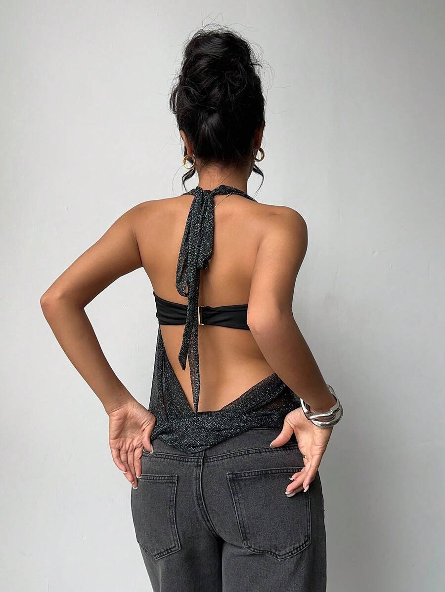 Brown and white polka dot semi-sheer halter camisole top with a plunging neckline, backless design, draped front, and metallic studded embellishments.