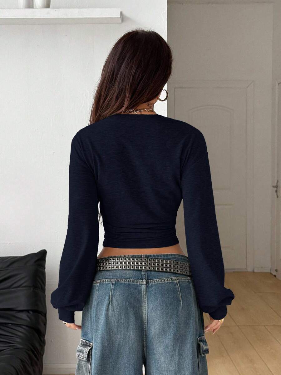 Women's casual long sleeve pullover sweatshirt with bishop sleeves and rib-knit detailing in navy blue.