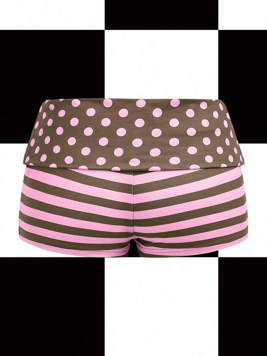Women's black low waist mini track shorts with contrast polka dot, striped, geometric, and plant-inspired print details, elastic waistband, and skinny fit