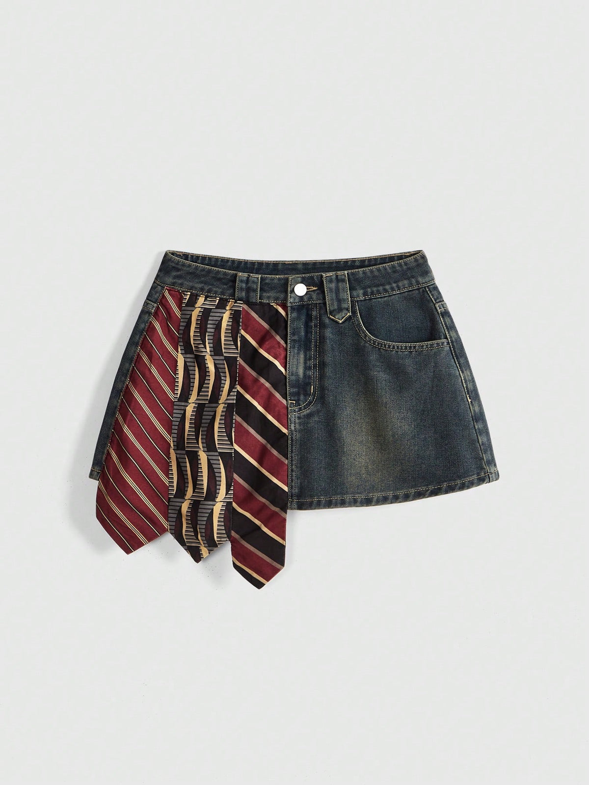 Women's low-waist asymmetrical mini skort featuring button, zipper, and pocket details in an A-line cut.