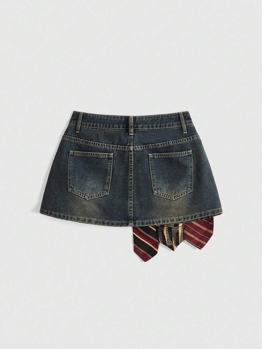 Women's low-waist asymmetrical mini skort featuring button, zipper, and pocket details in an A-line cut.