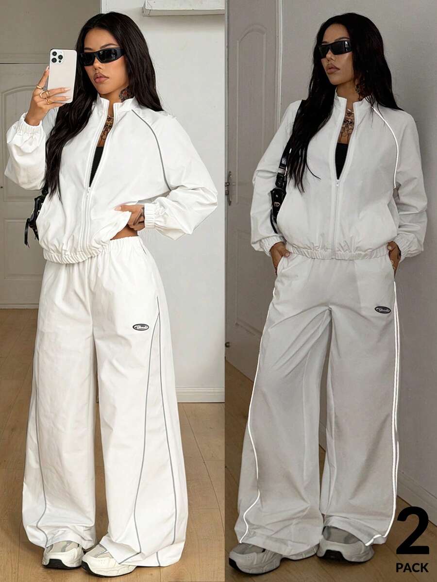 Women's two-piece sporty casual tracksuit set featuring a stand collar zip-up jacket with contrast binding and matching loose parachute pants.
