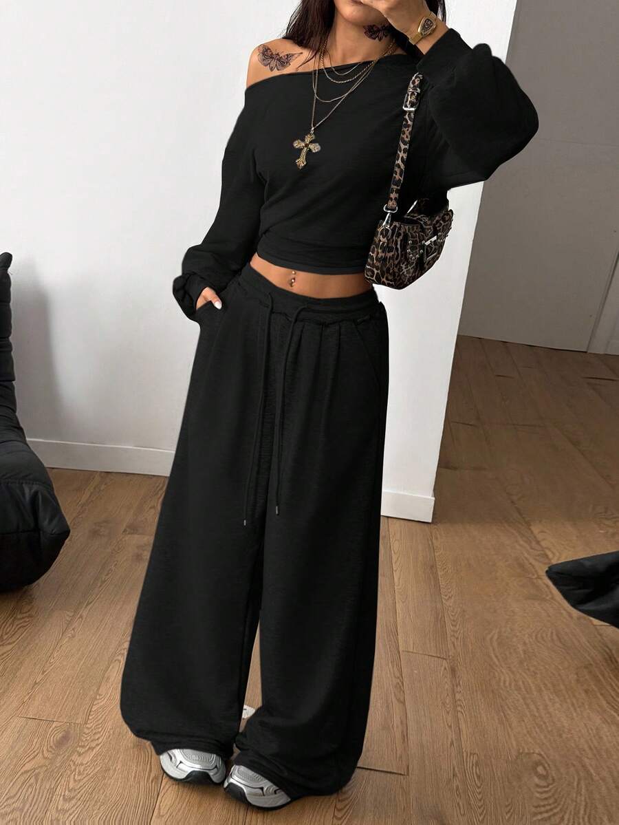 Women's two-piece casual lounge set featuring a loose drop-shoulder long sleeve sweatshirt and high-waist drawstring sweatpants with pockets.