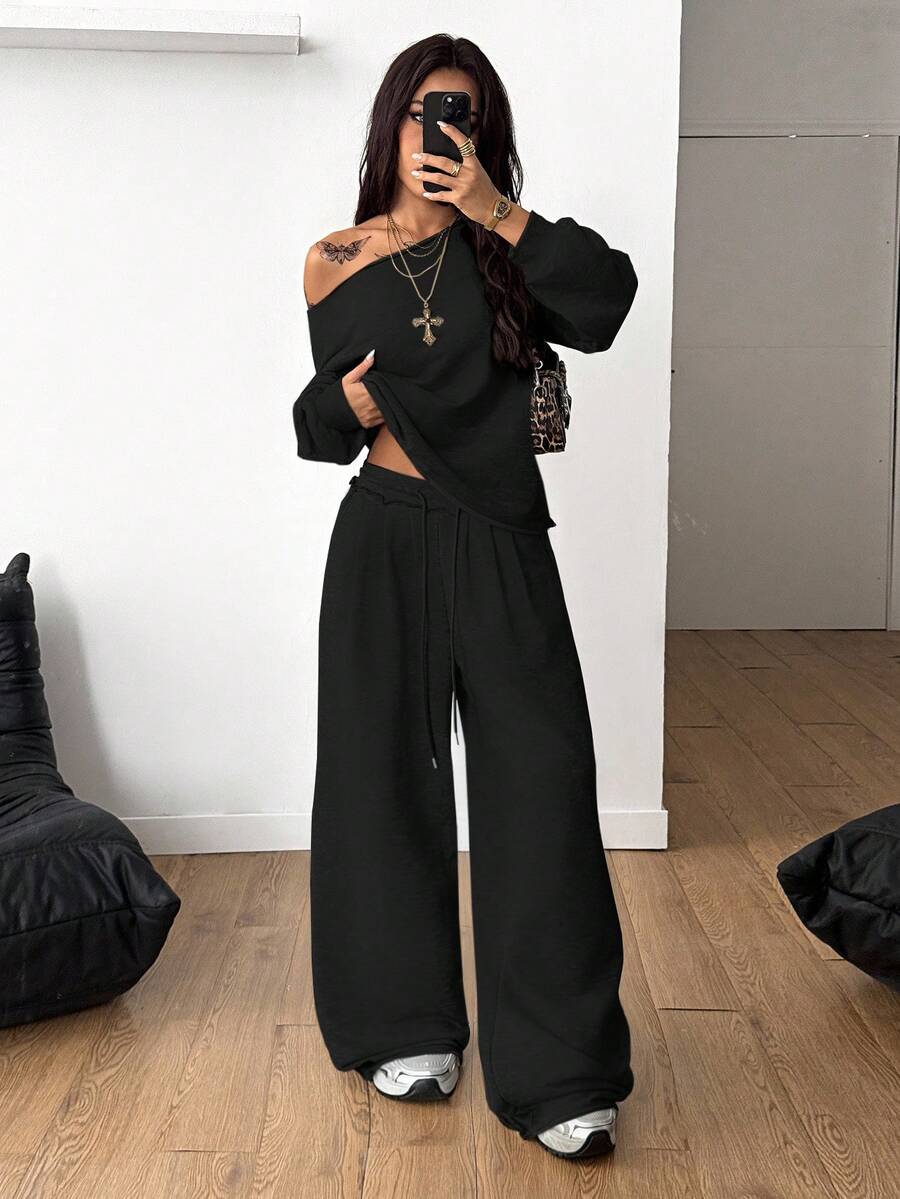 Women's two-piece casual lounge set featuring a loose drop-shoulder long sleeve sweatshirt and high-waist drawstring sweatpants with pockets.