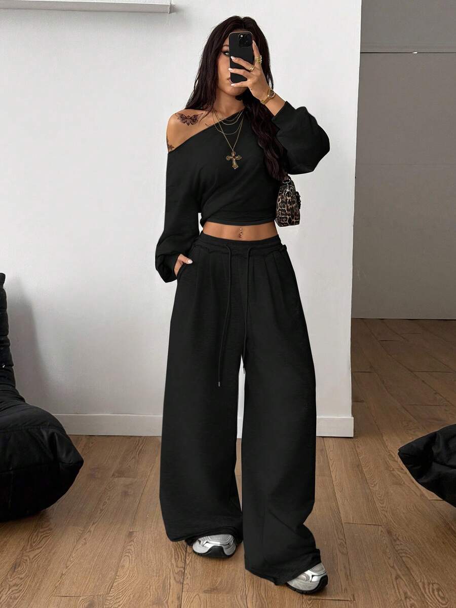 Women's two-piece casual lounge set featuring a loose drop-shoulder long sleeve sweatshirt and high-waist drawstring sweatpants with pockets.